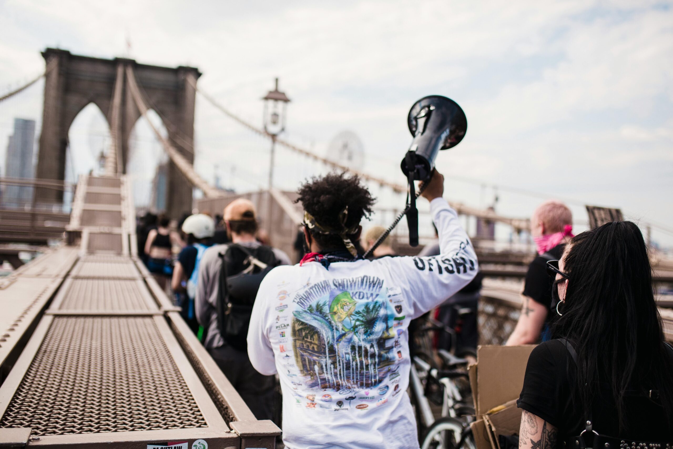 Group of activists holding a protest on the iconic Brooklyn Bridge, New York City.